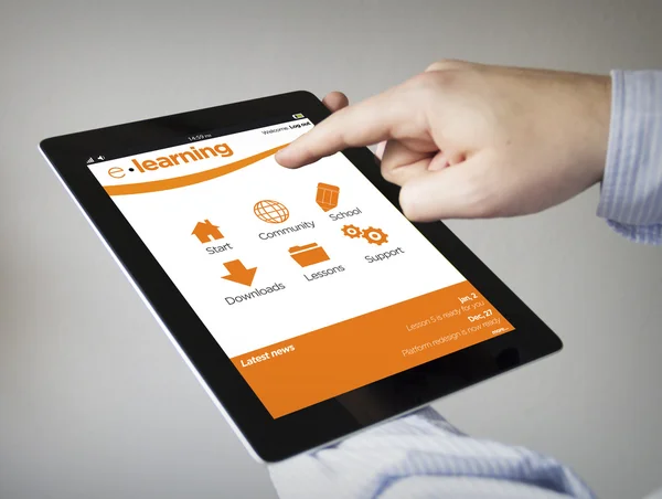 Hands with tablet with e-learning on the screen