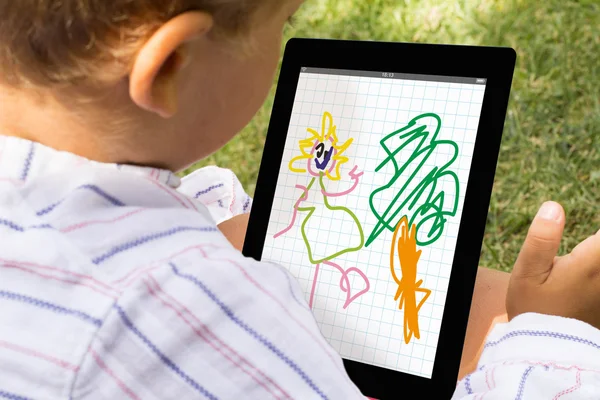 Kid drawing on tablet