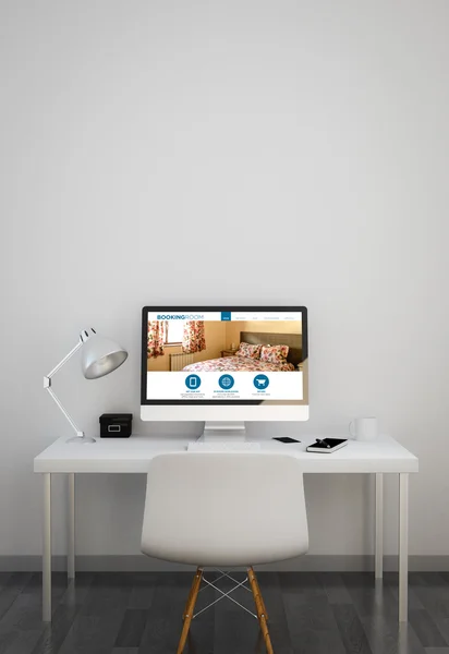 Clean workspace with booking website on computer screen