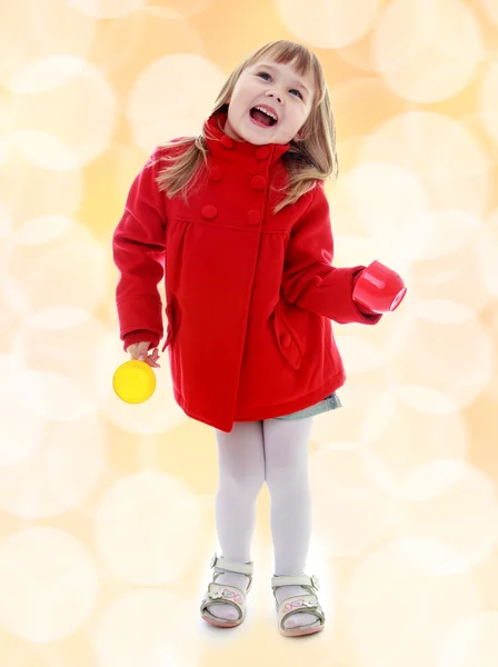 Charming little girl in a red coat