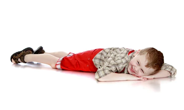 Fun boy lying on the floor