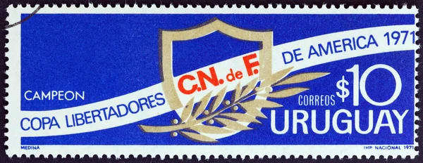 URUGUAY - CIRCA 1971: A stamp printed in Uruguay issued for Uruguay\'s victory in the Liberators of America Cup shows shield and laurel, circa 1971.