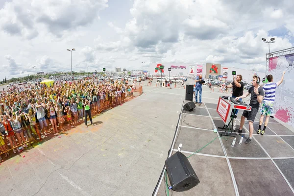 DJ rocks the crowd of young people on the festival of colors