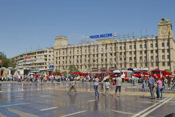 Fire engines at the exhibition under the open sky demonstrate the possibility of a fire hose