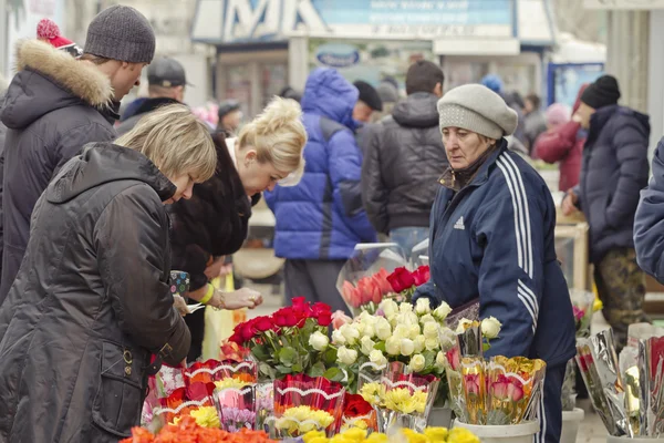 Selling flowers at a makeshift flower markets on the eve of international women\'s day