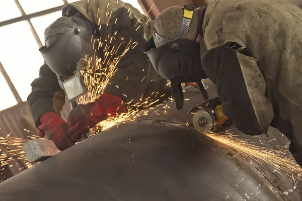 Welders weld multi-pass weld of the shell of the heat exchanger