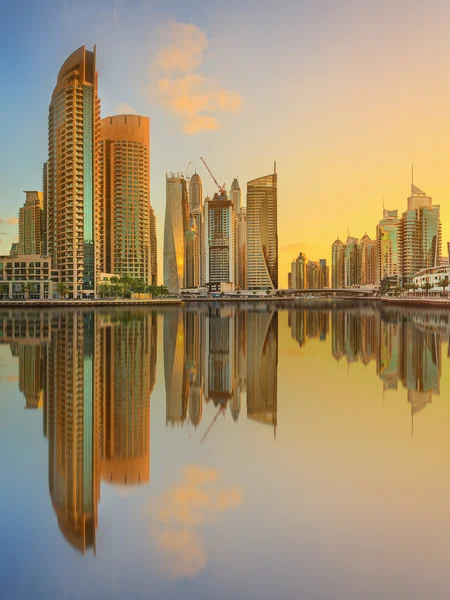 Panoramic view of Dubai Marina bay with yacht and cloudy sky, Dubai, UAE