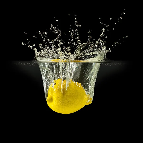 Fresh fruits falling in water with splash on black background