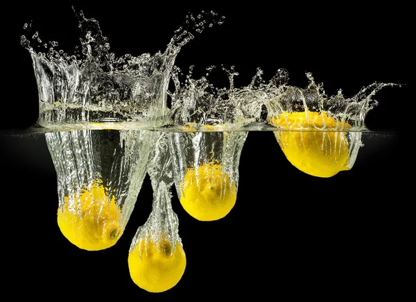 Group of fresh fruits falling in water with splash on black background