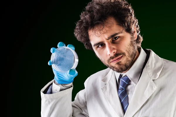 Researcher holding an empty petri dish