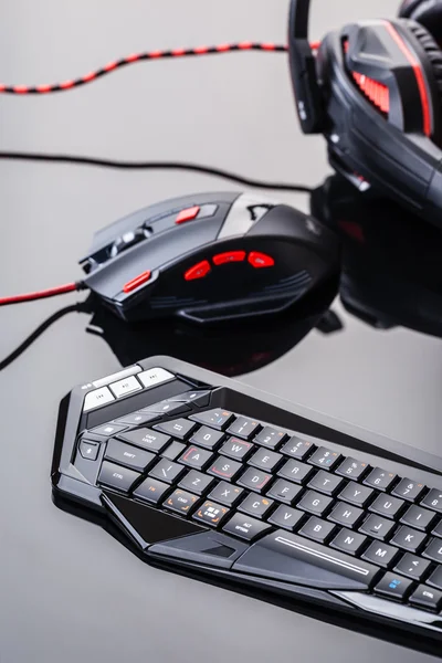 Gaming keyboard and mouse on shiny surface