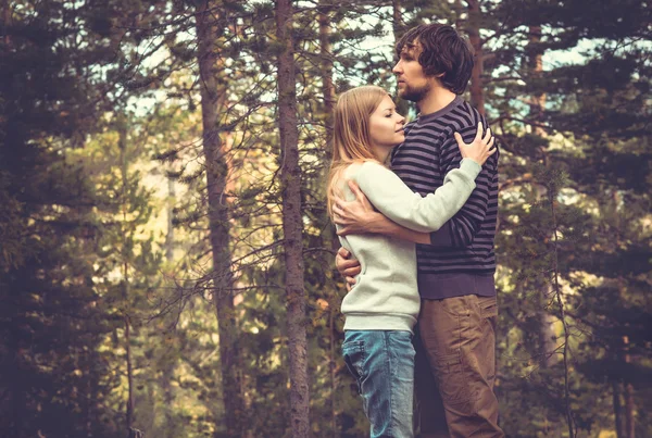 Young Couple Man and Woman Hugging in Love Romantic Outdoor with forest nature on background Fashion trendy style