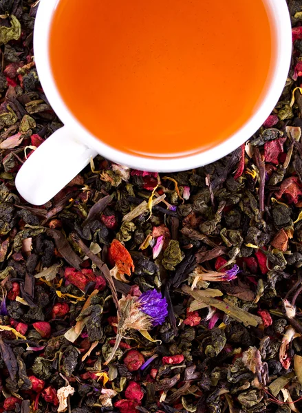 White porcelain cup of tea on a background of flower tea