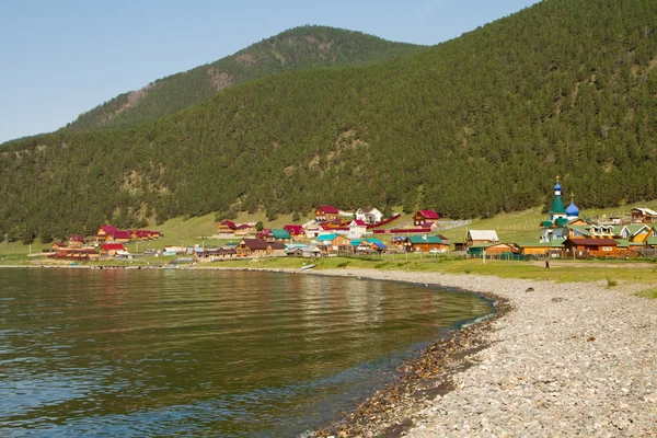BOLSCHOYE GOLOUSTNOYE, RUSSIA - JULY 10: Shore of Lake Baikal and the view of the recreation center in sunny weather on July 10, 2015 in Bolschoye Goloustnoye.