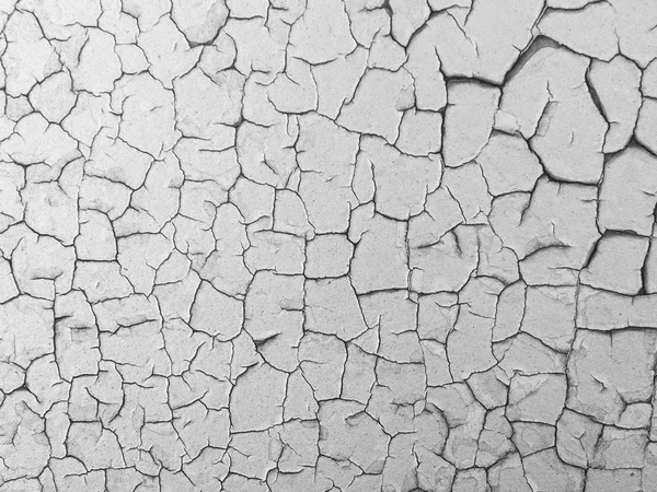 Cracked paint on rusty metal wall.