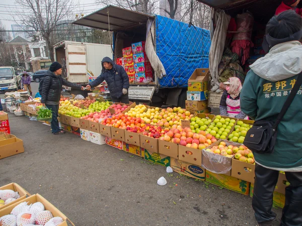 Street fruit seller on street market in China.