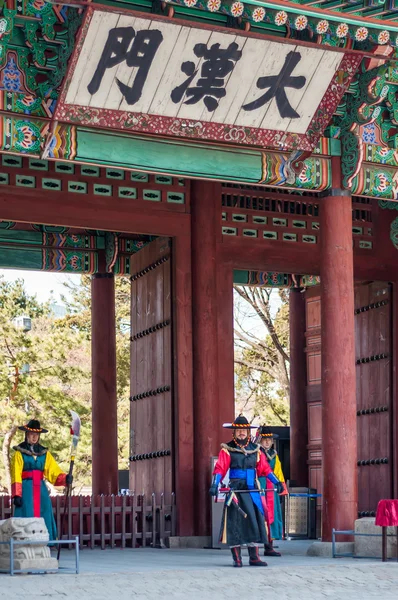 Armed soldiers in period costume guard at  gate of Deoksugung Pa
