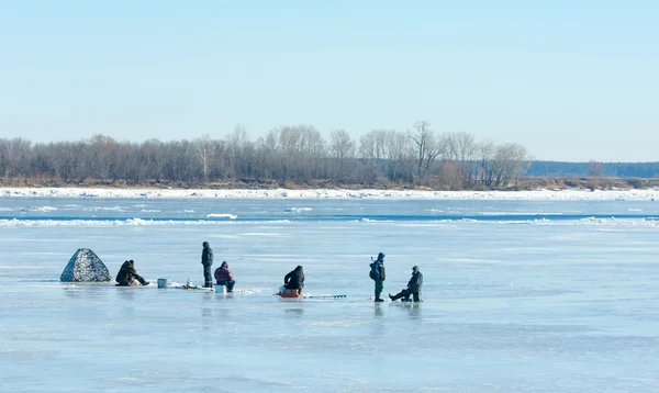 River flood fishermen. Torn river ice fishermen. River with the