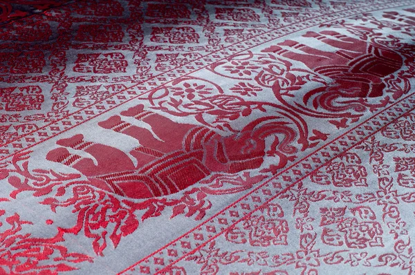 The texture of cotton fabric, with red painted elephants, made i