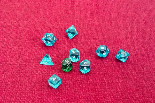 Specialized polyhedral dice for role-playing games on red cloth