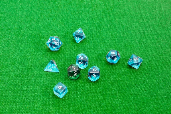 Specialized polyhedral dice for role-playing games on green clot