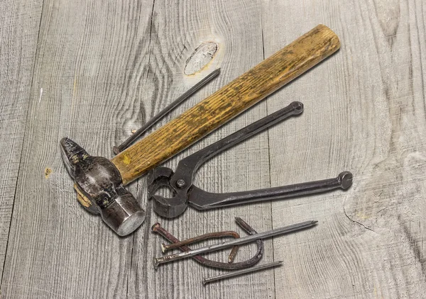 Old hammer, pincers and nails