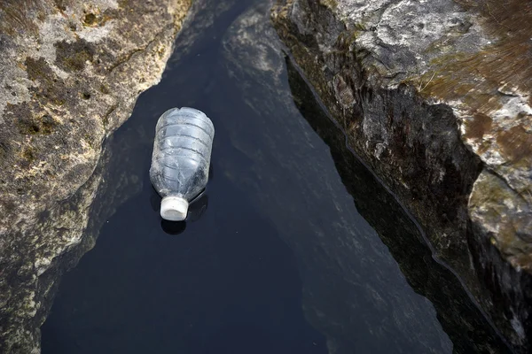 Empty water bottle floating in lake