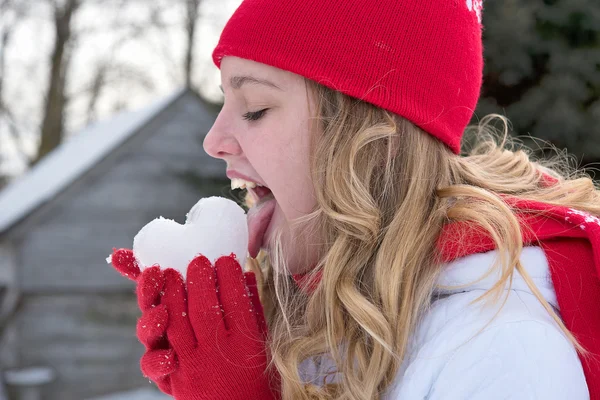 Teenage girl licking an ice heart