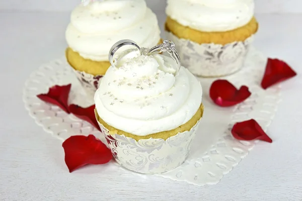 Wedding rings in cupcake frosting