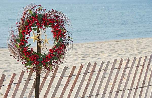 Christmas wreath on beach fence