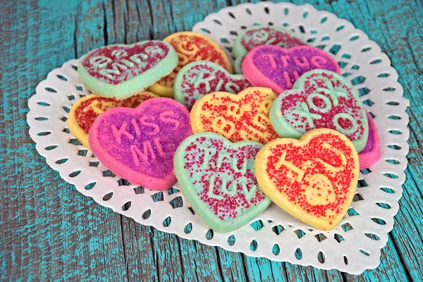 Valentine heart sugar cookies on wood