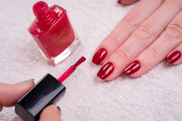 Manicured nails with red nail polish
