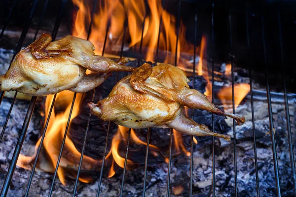 Grilling poultry quails in a restaurant