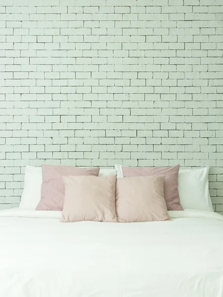 The bed on white bricks wall background vertical
