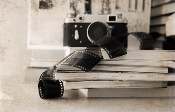 Artwork in retro style, old camera, film, books