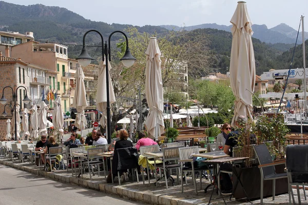 PORT DE SOLLER, MALLORCA, SPAIN, APRIL 6, 2016: Unidentified people eating in a restaurant in Port de Soller. It\'s a beautiful harbor town and very popular tourist resort in Mallorca.