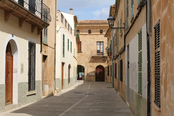 ALCUDIA, MAJORCA, SPAIN, APRIL 4, 2016: one of the charming streets in Alcudia. It\'s a very popular tourist destination in Mallorca, known from very well preserved the character of a historic town.