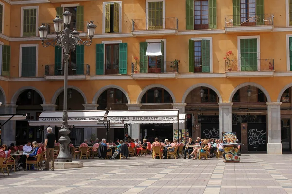PALMA DE MALLORCA, MAJORCA, SPAIN, APRIL 3, 2016: green shutters and restaurants at Plaza Mayor - main square in historic center of Palma de Mallorca