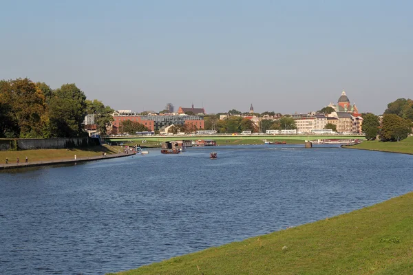 KRAKOW -SEPTEMBER 22: Vistula boulevards and Debnicki bridge; on September 22, 2015 n Krakow, Poland. Krakow is the most visited city in Poland. In 2012 the city was visited by 10 million tourists