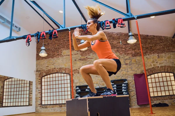 Woman doing ox jump exercise