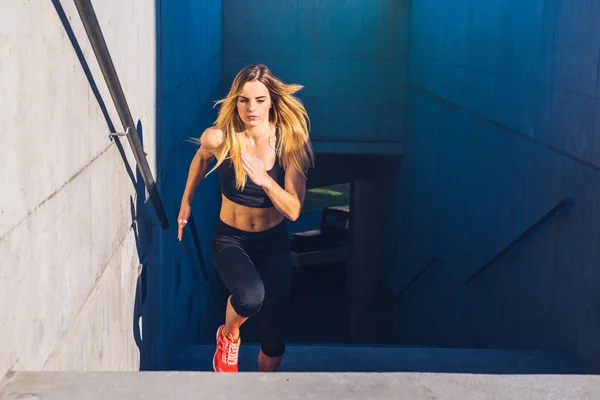 Female running fast up the stairs