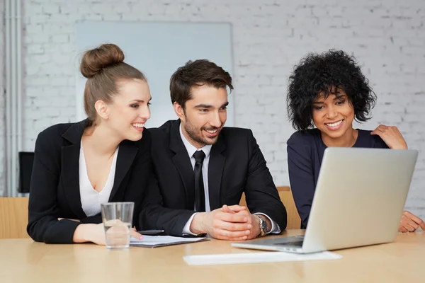 Business people looking at laptop