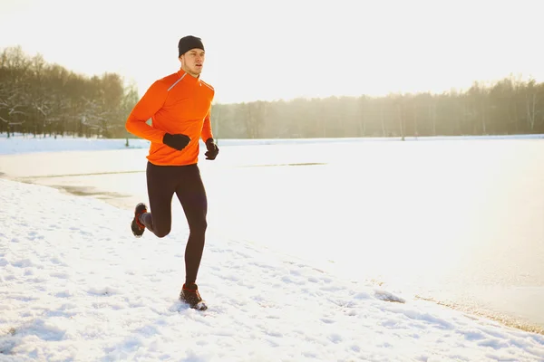 Man running at winter in park