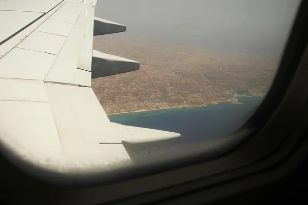 Wing of aircraft in sky