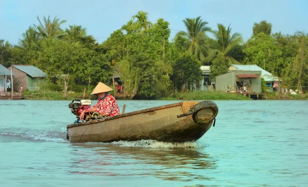Can Tho, Vietnam - 5 March 2015: Woman moving by rowing boat, the most common transportation mean of rural people in Mekong delta Vietnam