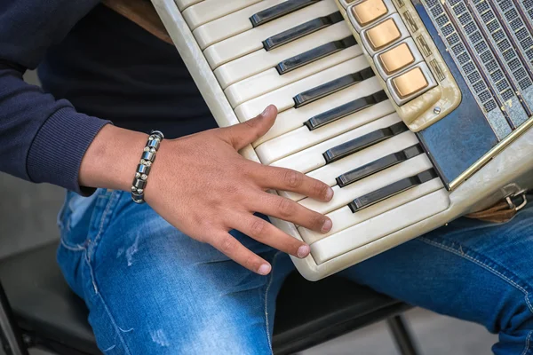 Closeup of musician hand playing an accordion