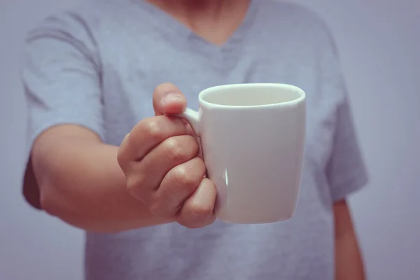 Hands holding coffee cup with filter effect retro vintage style