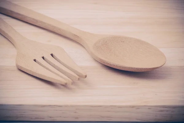 Wooden spoon on wood table with filter effect retro vintage styl