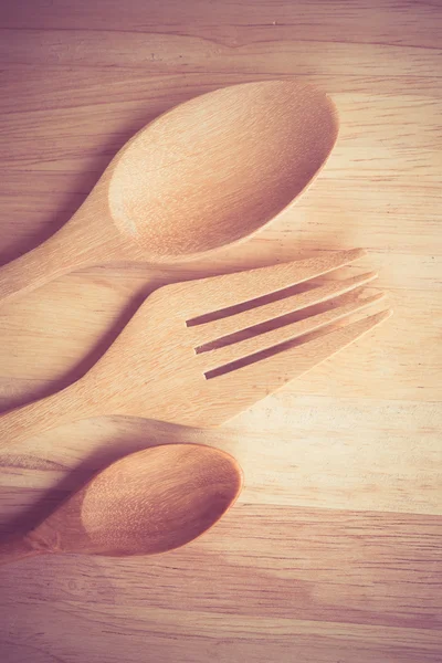 Wooden spoon  on wood table with filter effect retro vintage style