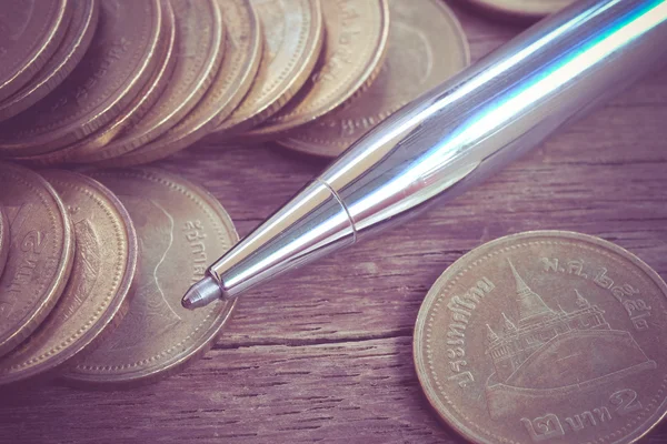 Pen and coins with filter effect retro vintage style